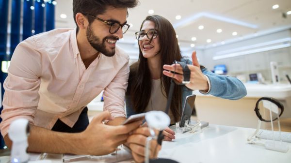 Man and woman looking at a watch