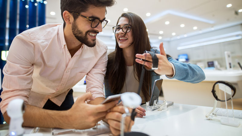 Man and woman looking at a watch