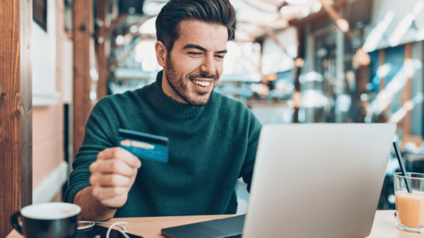 Man with card and laptop