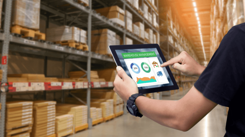 Person holding a tablet in a warehouse