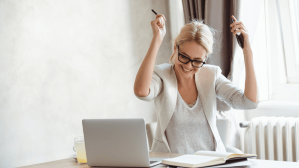 Person happy near laptop